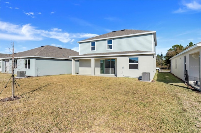 back of property with a yard and cooling unit