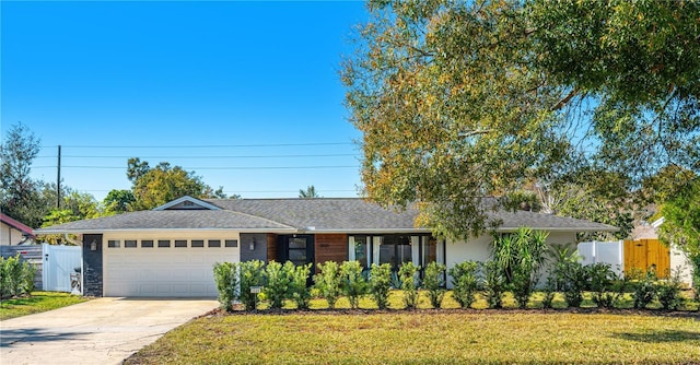 ranch-style house with a front yard and a garage