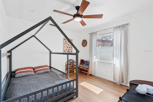 bedroom with ceiling fan and light hardwood / wood-style flooring