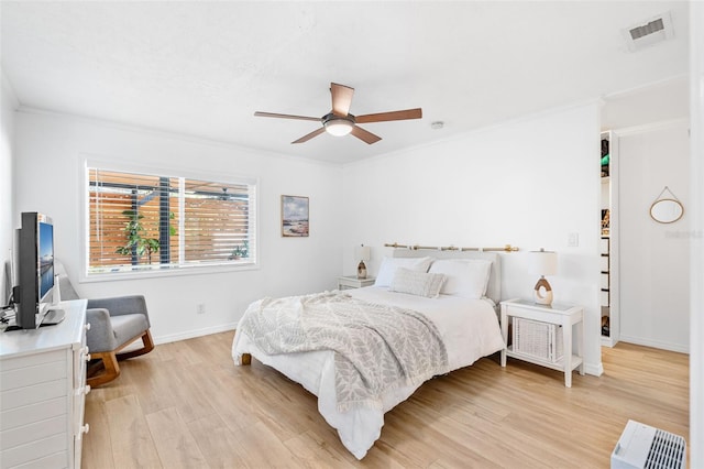 bedroom featuring ornamental molding, light wood-type flooring, and ceiling fan