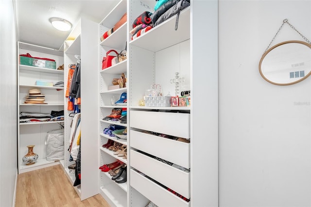 spacious closet featuring light hardwood / wood-style floors