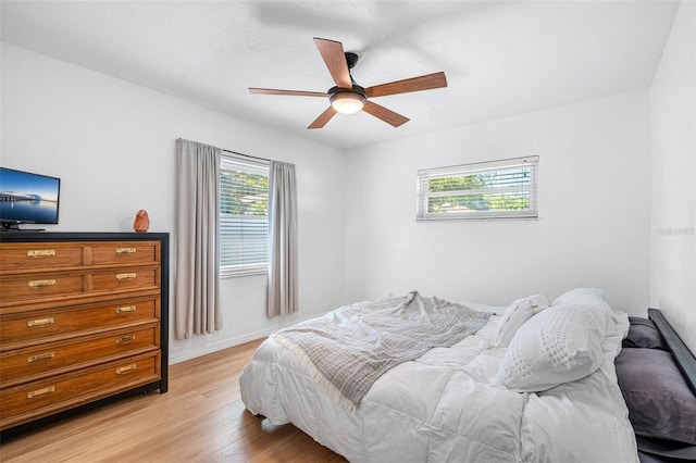 bedroom with ceiling fan and light hardwood / wood-style floors