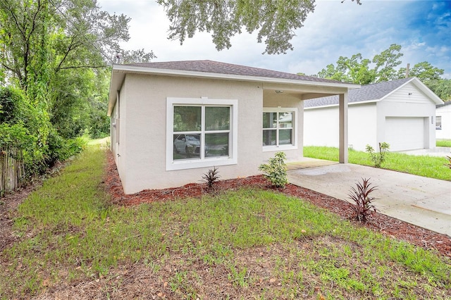 view of front of property with a front lawn and a garage