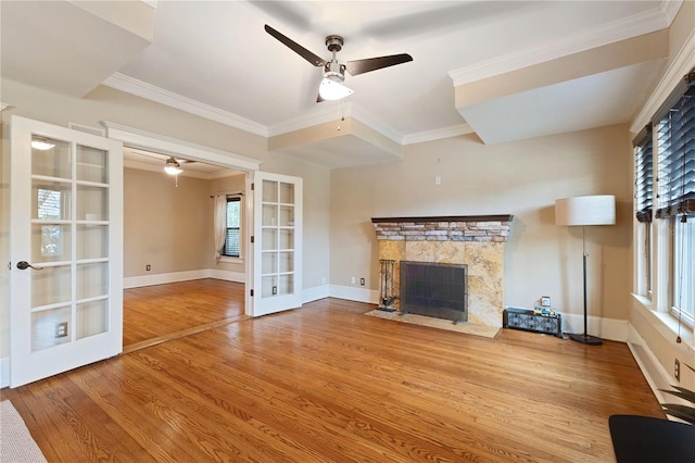 unfurnished living room featuring ceiling fan, light hardwood / wood-style floors, ornamental molding, and french doors