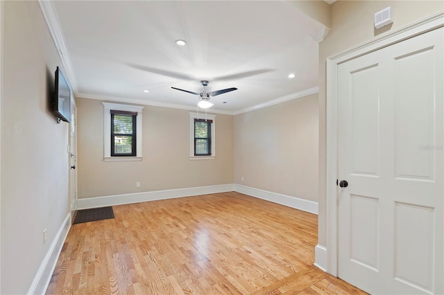 unfurnished room featuring light wood-type flooring, ceiling fan, and ornamental molding