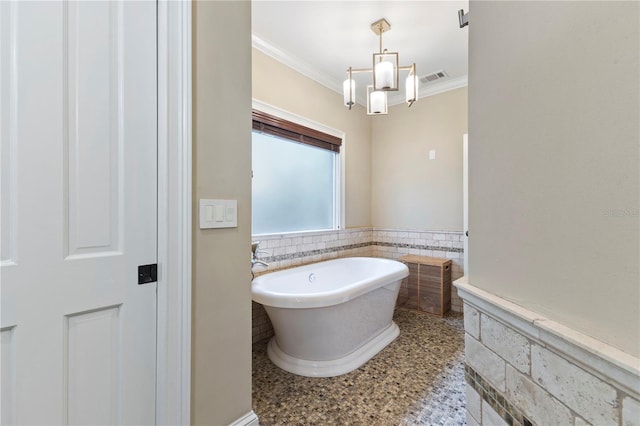 bathroom with ornamental molding and a bathtub