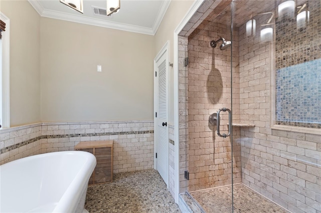 bathroom with tile walls, ornamental molding, and plus walk in shower