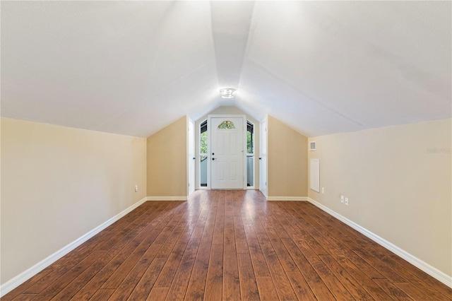 additional living space featuring lofted ceiling and dark wood-type flooring