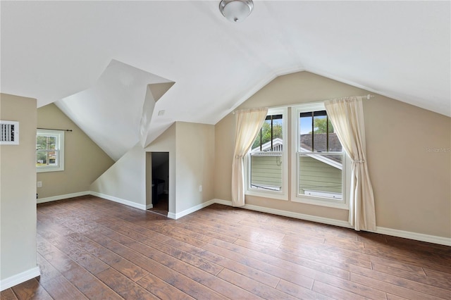 additional living space with lofted ceiling and dark hardwood / wood-style flooring