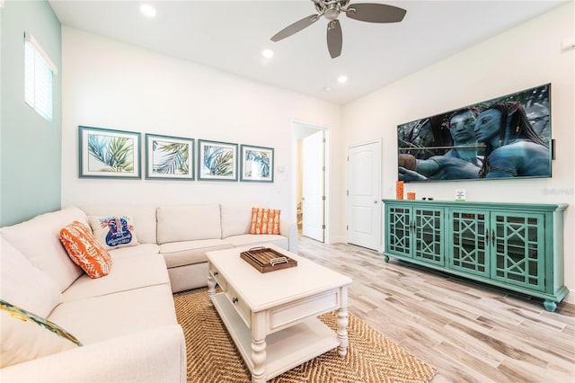 living room with ceiling fan and light hardwood / wood-style flooring