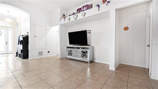 unfurnished living room with light tile patterned floors