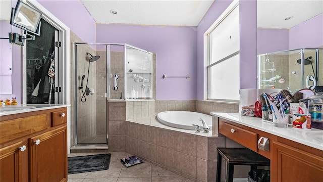 bathroom featuring independent shower and bath, tile patterned flooring, and vanity