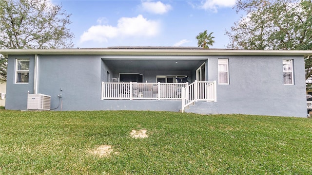 back of house with a yard and central AC unit