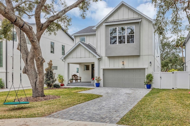 view of front facade featuring a garage, a front yard, and a porch