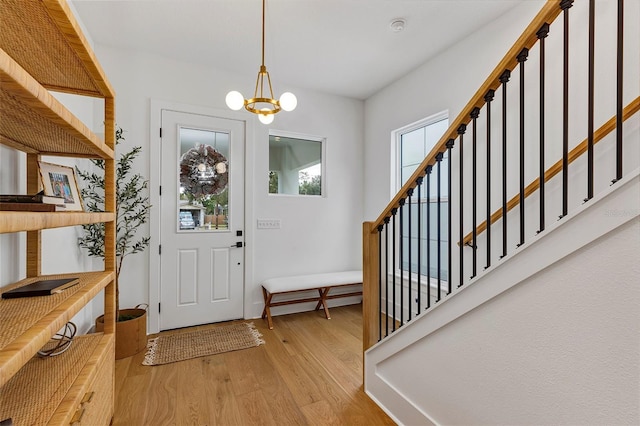 foyer entrance featuring light hardwood / wood-style flooring and an inviting chandelier