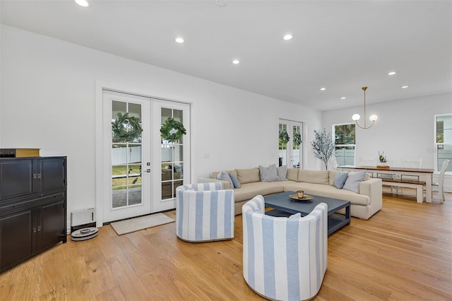 living room with french doors and light hardwood / wood-style floors