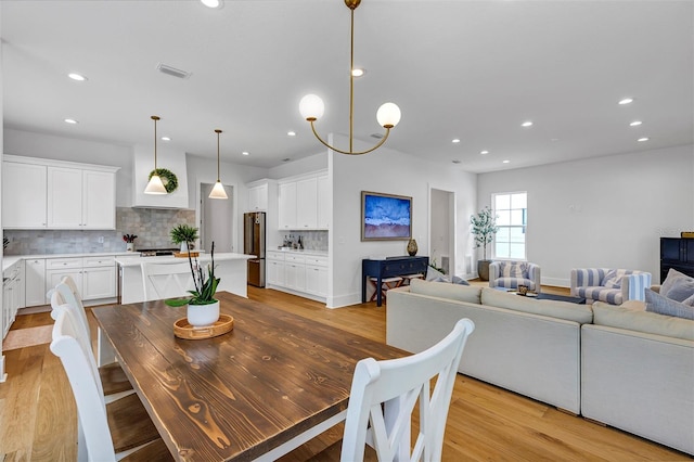 dining area featuring a chandelier and light hardwood / wood-style floors