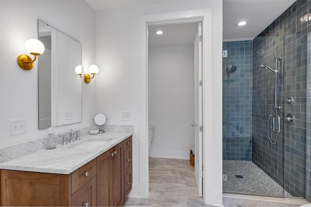 bathroom featuring toilet, vanity, and walk in shower