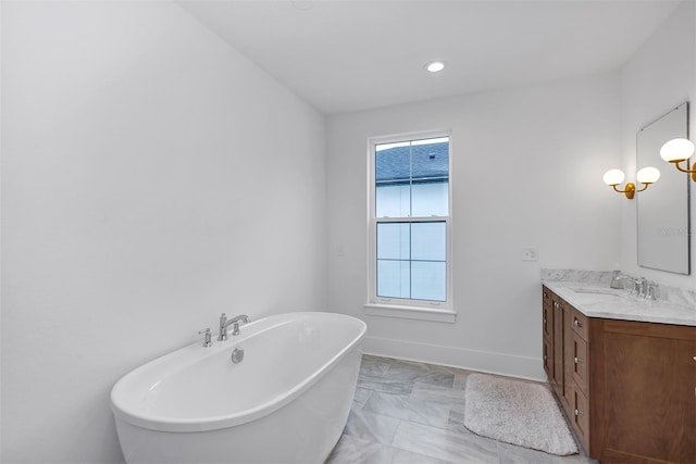 bathroom with a tub to relax in and vanity