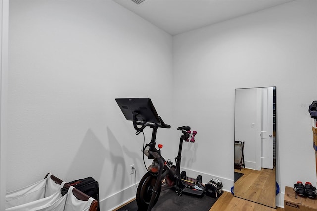 workout room featuring light wood-type flooring