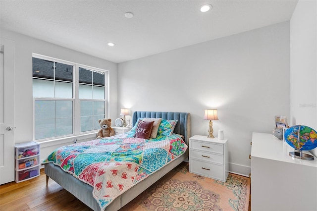 bedroom with wood-type flooring