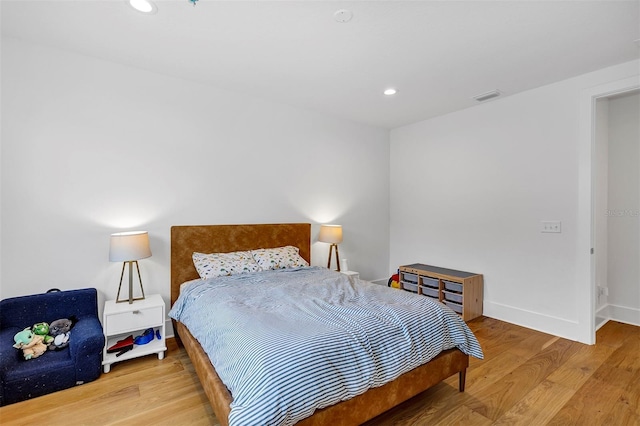 bedroom with hardwood / wood-style floors