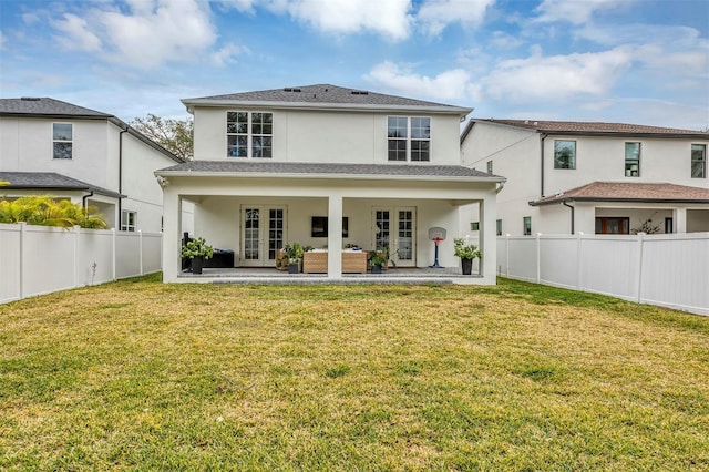 rear view of house with an outdoor living space, a lawn, french doors, and a patio