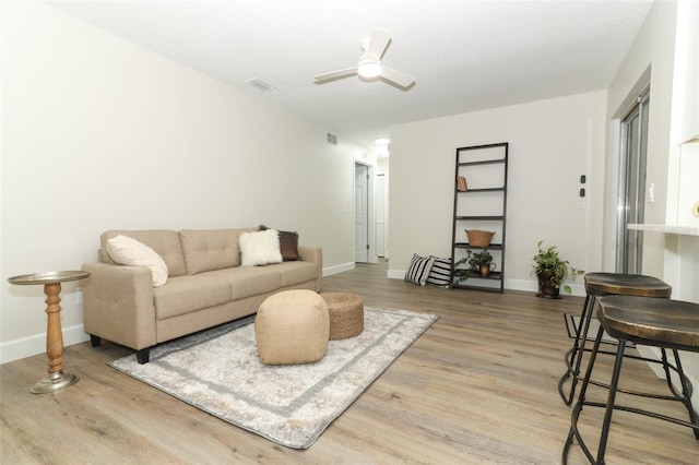 living room featuring ceiling fan and wood-type flooring