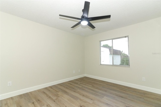 spare room featuring ceiling fan, a textured ceiling, and hardwood / wood-style flooring