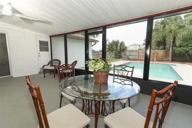 sunroom / solarium with ceiling fan, vaulted ceiling, and wood ceiling