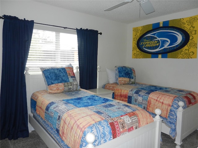 carpeted bedroom with a textured ceiling and ceiling fan