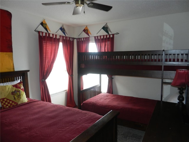 bedroom featuring ceiling fan and a textured ceiling