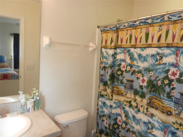 bathroom featuring toilet, a shower with shower curtain, and vanity