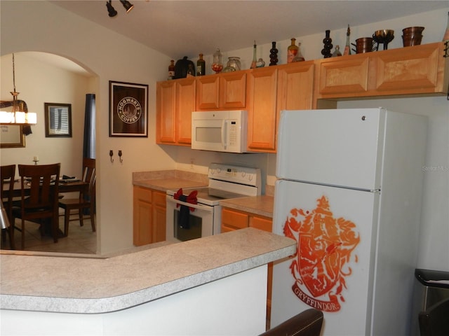 kitchen with white appliances and hanging light fixtures