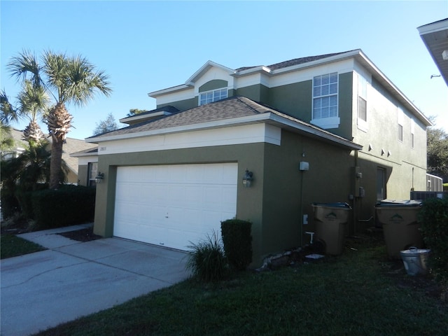 2803 Lido Key Ct, Kissimmee, FL 34747 - view of home's exterior featuring stucco siding, driveway, a garage, and a shingled roof