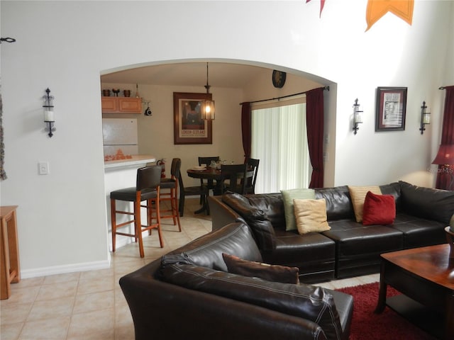 2803 Lido Key Ct, Kissimmee, FL 34747 - living area with arched walkways, light tile patterned floors, and baseboards