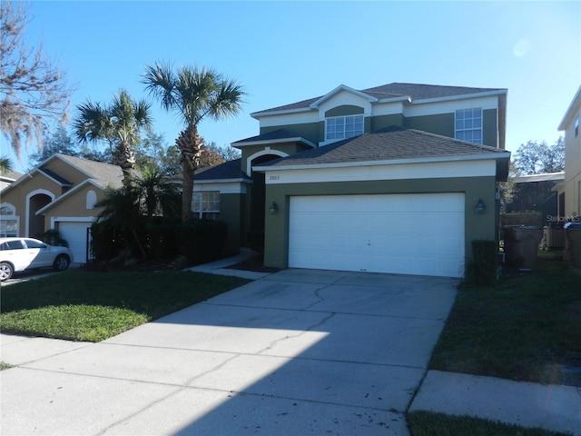 2803 Lido Key Ct, Kissimmee, FL 34747 - traditional-style house with stucco siding, a garage, driveway, a shingled roof, and a front lawn