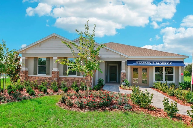 view of front of house featuring french doors and a front yard