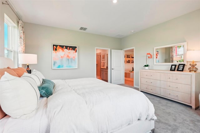 carpeted bedroom featuring connected bathroom