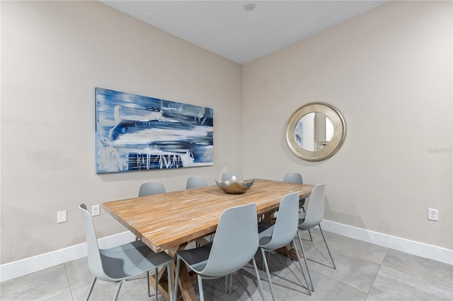 dining space featuring light tile patterned floors