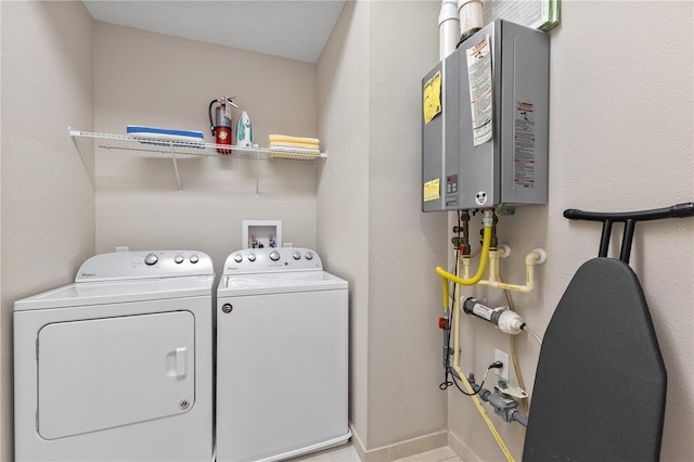 washroom featuring washer and clothes dryer and tankless water heater