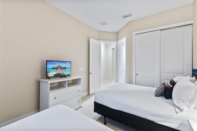 bedroom with a closet and light carpet