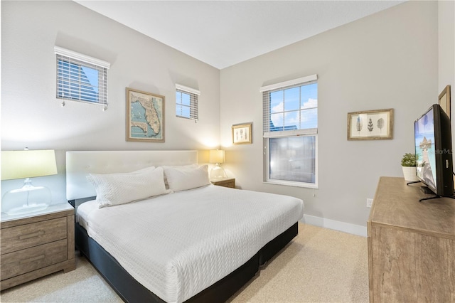 bedroom featuring light colored carpet