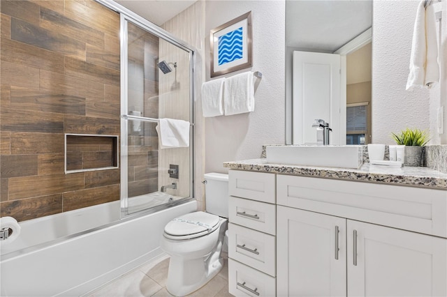 full bathroom featuring bath / shower combo with glass door, toilet, tile patterned flooring, and vanity