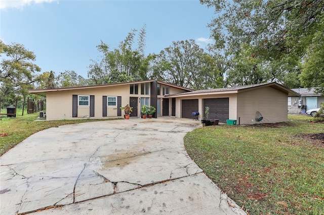 ranch-style house featuring a garage and a front lawn