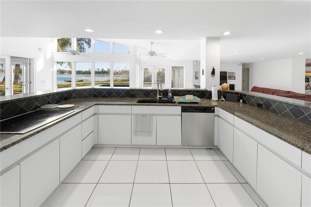 kitchen featuring stainless steel dishwasher, white cabinetry, sink, and cooktop