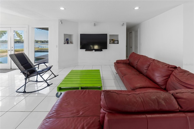 living room with french doors and light tile patterned flooring