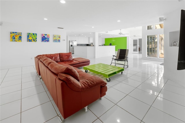 tiled living room with ceiling fan