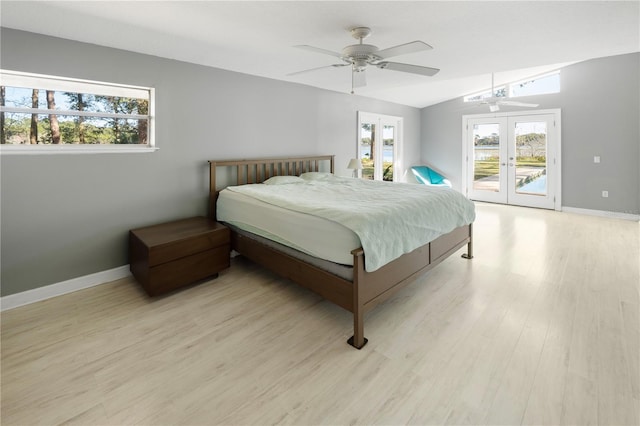 bedroom featuring french doors, multiple windows, ceiling fan, and access to outside