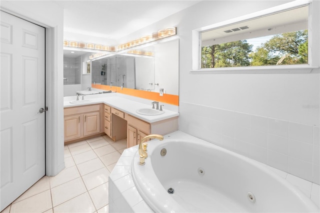 bathroom with vanity, tile patterned floors, and a relaxing tiled tub